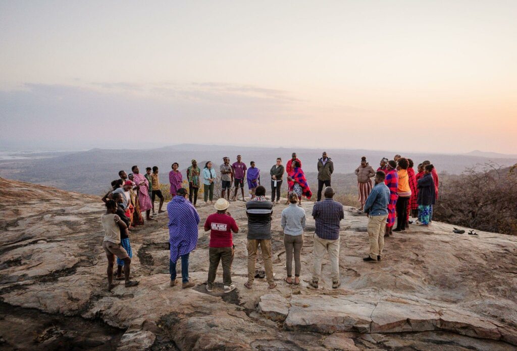 Participants gathered in a circle at the edge of a cliff.